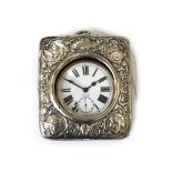 A silver mounted easel watch stand, William Comyns, London 1910, embossed with angel masks,