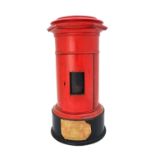 A red painted wooden domestic postal box, 20th century, of pillar form, on an ebonised base (a.