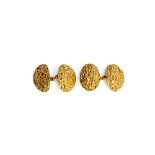 A pair of 18ct gold cufflinks, the backs and the fronts of dished oval form, with a textured finish,