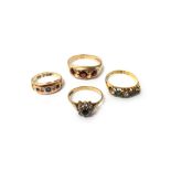 A 9ct gold and garnet set three stone ring, an 18ct gold,