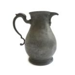 A quantity of mainly early 19th century pewter wares, lidded jugs,