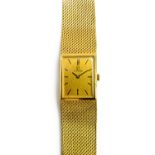 An Omega 18ct gold rectangular cased bracelet wristwatch, the signed rectangular gilt dial,