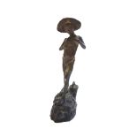 A 19th century patinated bronze figure of a young boy holding a fish, indistinctly signed,