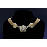 A gold and diamond floral necklace, the principal transition cut diamond weighing 3.