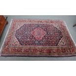 A Malayer rug, Persian, the madder field with a pink diamond, ivory spandrels,