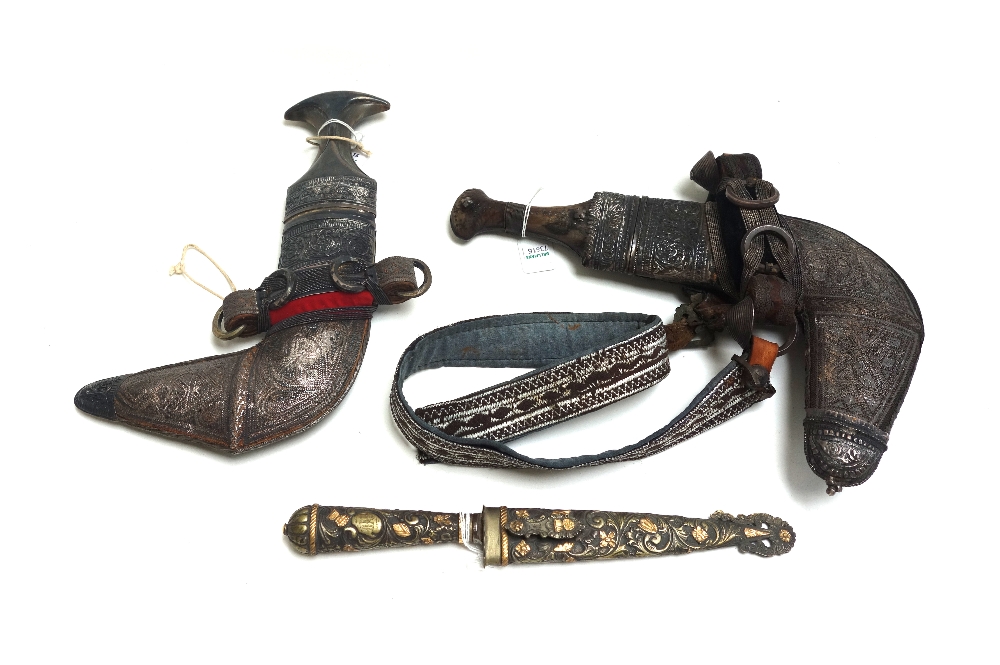 Two Middle Eastern jambiya, 20th century, with curved double edged steel blades,