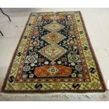 A Shirvan rug, Caucasian, the black field with three diamonds, stylised motifs, animals, birds,