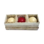 A set of three Burroughes & Watts ivory billiard balls, early 20th century, boxed.