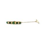 A gold, emerald and cultured pearl brooch, mounted with a row of five cushion shaped emeralds,