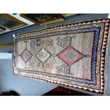 A Soumac rug, Caucasian, the madder field with two sage and ivory diamonds,