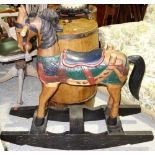 A 20th century carved and painted hardwood rocking horse on an ebonised base.