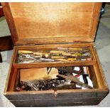 A quantity of assorted carpentry tools contained in a pine trunk.