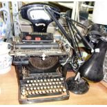 A set of weighing scales, a Remington typewriter and three desk lamps, (5).