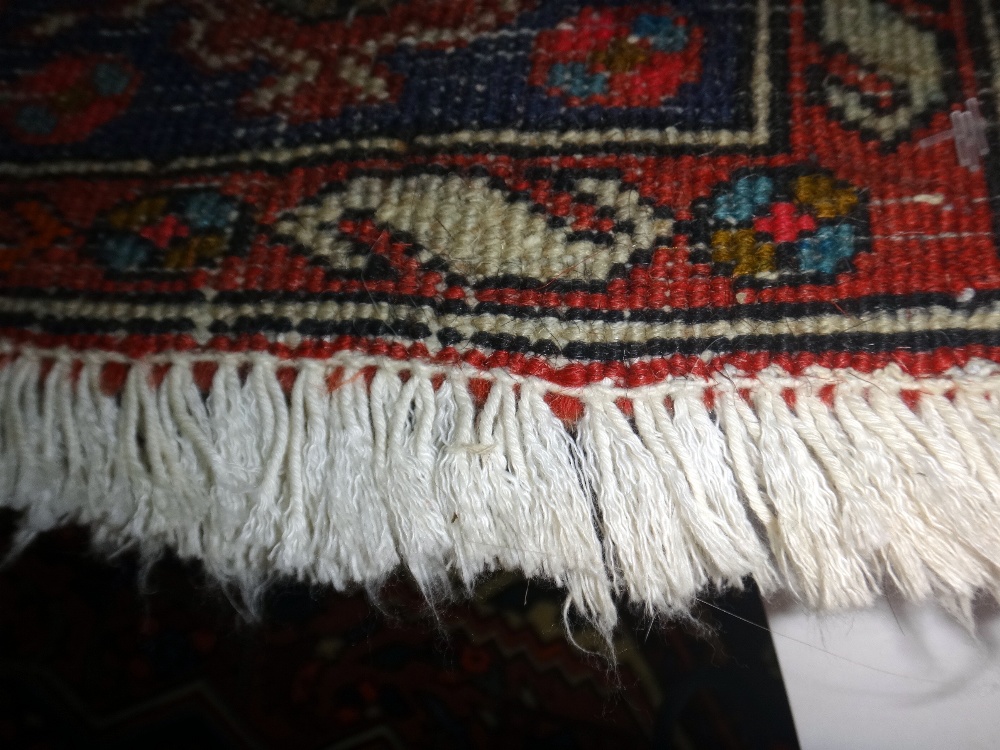 A Sarough rug, Persian, the madder floral field with stepped black medallion, ivory spandrels, - Image 3 of 8