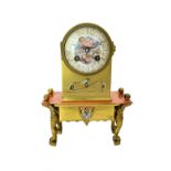 A French brass mantel clock, late 19th century, the porcelain dial painted with Cupid,