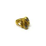 A gold and diamond ring, circa 1900, designed as two entwined serpents,