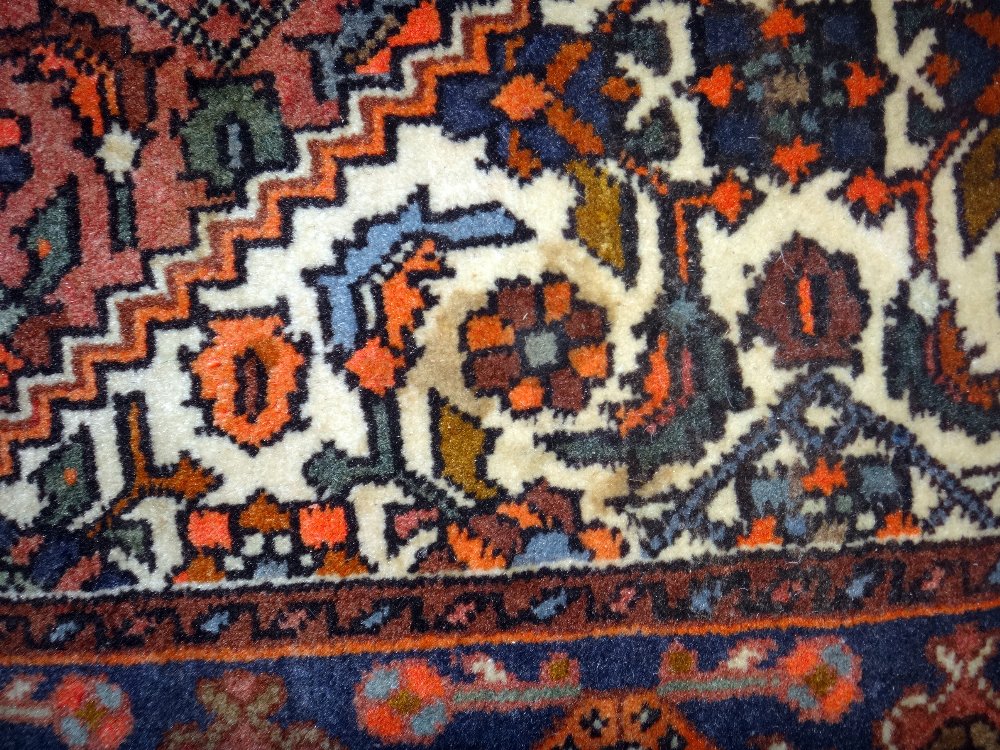 A Sarough rug, Persian, the madder floral field with stepped black medallion, ivory spandrels, - Image 8 of 8