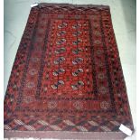 A Tekke Turkmen rug, the madder field with two columns of seven guls, supporting crosses,