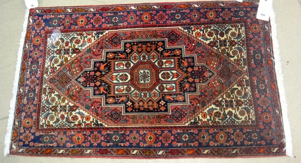 A Sarough rug, Persian, the madder floral field with stepped black medallion, ivory spandrels,