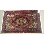 A Sarough rug, Persian, the madder floral field with stepped black medallion, ivory spandrels,
