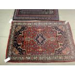 A Sarough rug, Persian, the madder field with black medallion, matching spandrels,