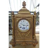 A 19th century French gilt metal mantel clock, the white enamel dial with slow/fast adjustment,