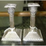 A pair of late Victorian silver candlesticks, each formed as a classical column,