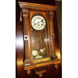 A group of three clocks including two mahogany mantel clocks and a walnut wall clock.