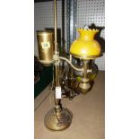 A brass oil lamp and three glass vases.