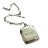 An Edwardian silver vesta case, Chester 1901, inscribed, to a silver watch chain with oval,