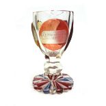 A German glass goblet, circa 1870, with ruby, amber and blue staining and two named scenes,