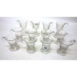 A set of eight George IV glass custard cups, with facet cutting, 8cm high and a further set of four,