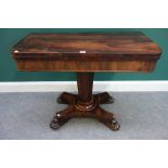 An early Victorian rosewood games table, on tapering octagonal column,
