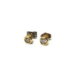 A pair of 9ct gold and diamond set single stone earstuds,