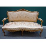 A Louis XV style gilt framed sofa,