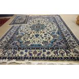 A modern Turkish Duruder carpet, the ivory field with an indigo rosette medallion,