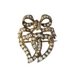 A Victorian diamond brooch, designed as two entwined hearts, with a ribbon tied bow surmount,