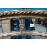 A George III style gilt framed oval margina mirror, 112cm wide x 83cm high.