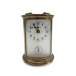 A gilt brass cased carriage clock of cylindrical form, early 20th century,