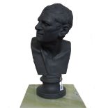 A Wedgwood style black basalt ware bust depicting a Greek philosopher, raised atop a socle,