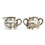 An Oriental twin handled sugar bowl and a matching milk jug,