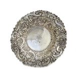 A late Victorian silver shaped circular dish, with floral, foliate and scroll embossed decoration,