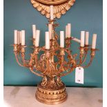 A Victorian seventeen light gilt bronze candelabrum, foliate cast, on a pierced circular base,