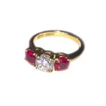 An 18ct gold, ruby and diamond three stone ring, centred with a round brilliant diamond, appox. 1.