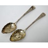 A pair of silver berry fruit serving spoons, with later embossed decoration, London 1829,