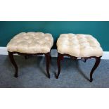 A pair of late 19th century French carved walnut square foot stools of serpentine outline on