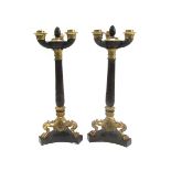A pair of patinated and gilt bronze three branch candelabra, 19th century,