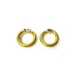 A pair of gold earclips, each of plain circular form, with post and folding clip fittings,