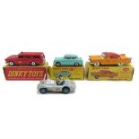 Four Dinky die-cast vehicles, comprising; 257 Canadian Fire Chief's car, 265 Plymouth USA taxi,
