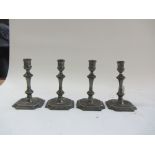 A set of four 18th century pewter candlesticks, each stamped 'MONMOUTH' to the canted square foot,